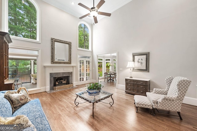 120 Forest Breeze Cv, Alpharetta, GA 30022 - living room featuring a high ceiling, ceiling fan, crown molding, a high end fireplace, and wood finished floors