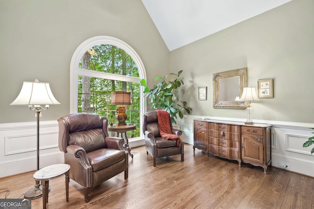 120 Forest Breeze Cv, Alpharetta, GA 30022 - sitting room featuring high vaulted ceiling, wainscoting, wood finished floors, and a decorative wall