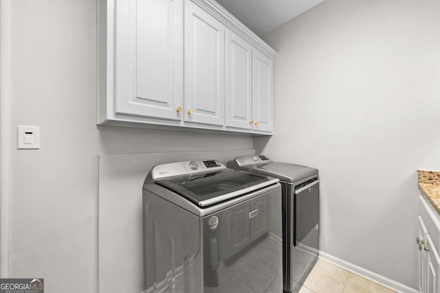 120 Forest Breeze Cv, Alpharetta, GA 30022 - laundry room featuring washing machine and clothes dryer, cabinet space, and light tile patterned floors