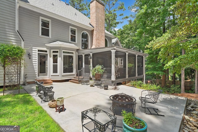 120 Forest Breeze Cv, Alpharetta, GA 30022 - back of property featuring an outdoor fire pit, a chimney, a patio area, a shingled roof, and a sunroom