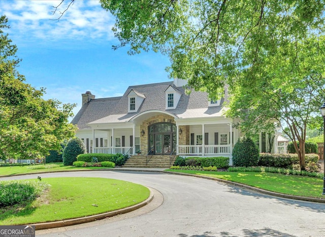 120 Forest Breeze Cv, Alpharetta, GA 30022 - cape cod house featuring a porch, a front yard, curved driveway, and stone siding