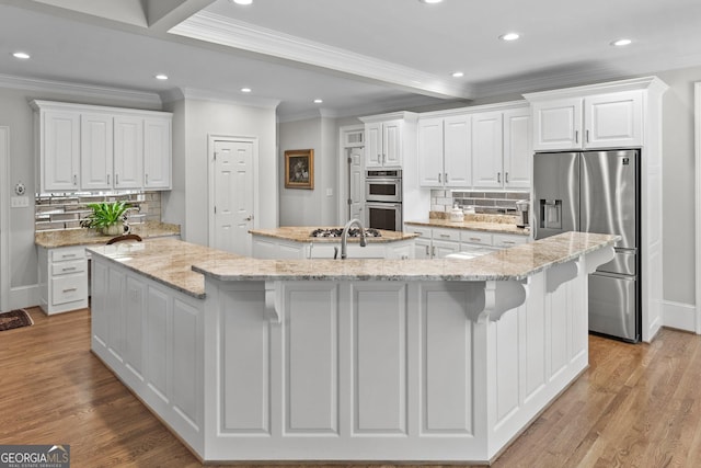 120 Forest Breeze Cv, Alpharetta, GA 30022 - kitchen featuring stainless steel appliances, a large island, crown molding, recessed lighting, and tasteful backsplash