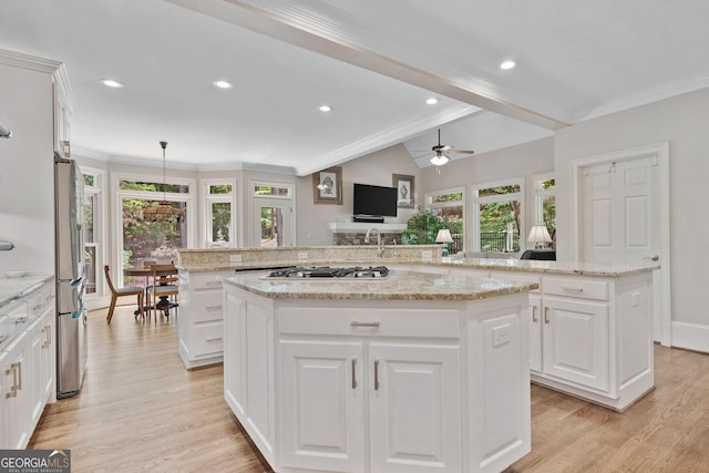 120 Forest Breeze Cv, Alpharetta, GA 30022 - kitchen featuring a center island, gas stovetop, light wood-style floors, healthy amount of natural light, and ornamental molding