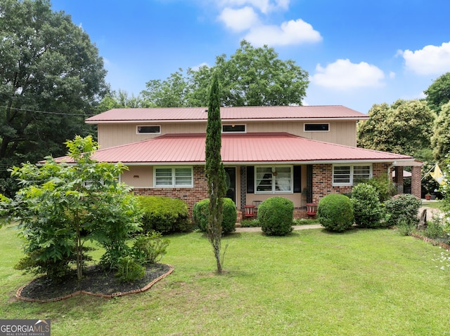 157 Glendale Hts, Winterville, GA 30683 - view of front of property with a front yard, a porch, metal roof, and brick siding