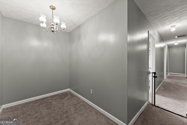 157 Glendale Hts, Winterville, GA 30683 - hallway with a textured ceiling, carpet, baseboards, and a chandelier