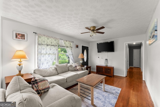 157 Glendale Hts, Winterville, GA 30683 - living room featuring a ceiling fan, a textured ceiling, wood finished floors, baseboards, and attic access