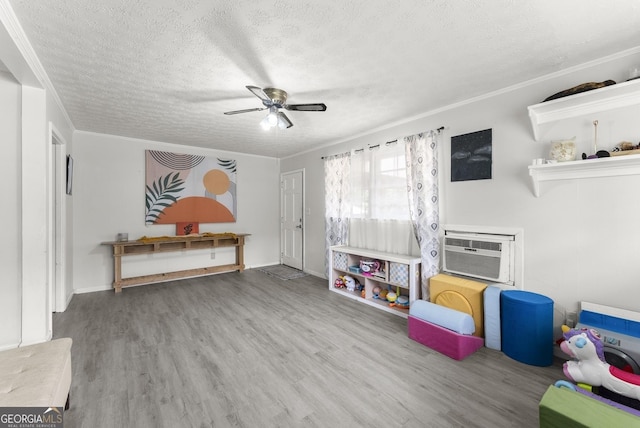 157 Glendale Hts, Winterville, GA 30683 - rec room with a textured ceiling, a wall mounted AC, ceiling fan, wood finished floors, and crown molding