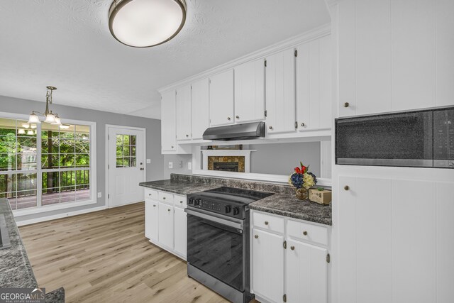 1407 Water Wheel Dr, Bethlehem, GA 30620 - kitchen with electric range, under cabinet range hood, stainless steel microwave, and dark countertops