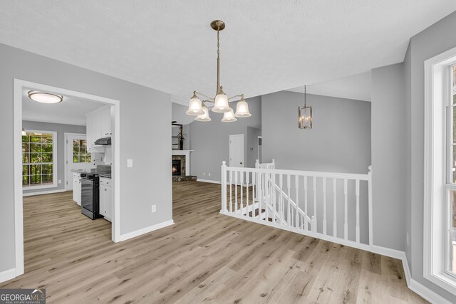 1407 Water Wheel Dr, Bethlehem, GA 30620 - unfurnished dining area featuring light wood-type flooring, a chandelier, and baseboards