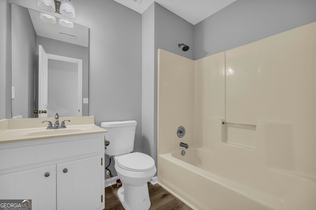 1407 Water Wheel Dr, Bethlehem, GA 30620 - full bathroom featuring toilet, vanity, wood finished floors, shower / bathtub combination, and baseboards