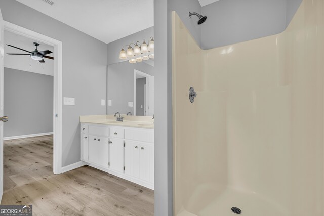 1407 Water Wheel Dr, Bethlehem, GA 30620 - full bathroom featuring double vanity, wood finished floors, a shower, and ceiling fan
