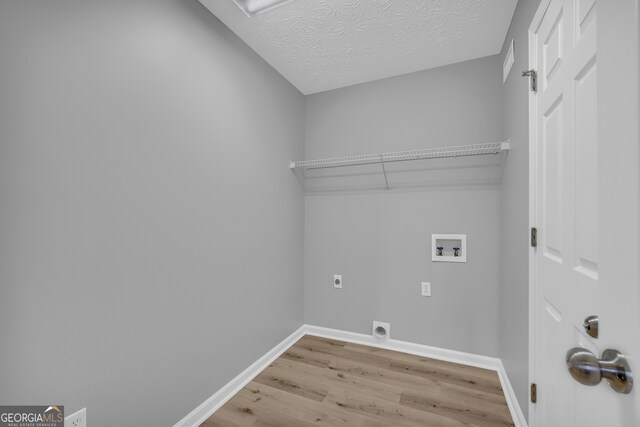 1407 Water Wheel Dr, Bethlehem, GA 30620 - laundry room with electric dryer hookup, light wood finished floors, hookup for a washing machine, baseboards, and a textured ceiling