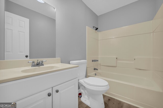1407 Water Wheel Dr, Bethlehem, GA 30620 - bathroom featuring toilet, vanity, wood finished floors, and bathing tub / shower combination