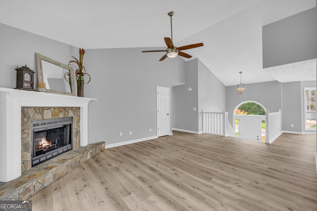 1407 Water Wheel Dr, Bethlehem, GA 30620 - unfurnished living room featuring high vaulted ceiling, wood finished floors, a ceiling fan, and baseboards