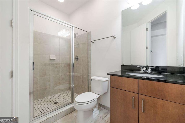 711 Cosmopolitan Dr NE Unit 300, Atlanta, GA 30324 - full bathroom with vanity, toilet, tile patterned flooring, a shower stall, and baseboards