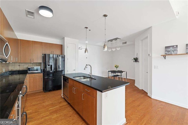 711 Cosmopolitan Dr NE Unit 300, Atlanta, GA 30324 - kitchen with appliances with stainless steel finishes, a sink, dark countertops, light wood-style flooring, and tasteful backsplash