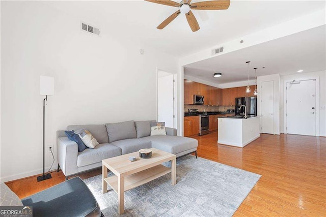 711 Cosmopolitan Dr NE Unit 300, Atlanta, GA 30324 - living area with ceiling fan, light wood-style flooring, and baseboards