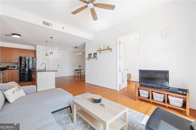 711 Cosmopolitan Dr NE Unit 300, Atlanta, GA 30324 - living room with ceiling fan, light wood-style floors, and baseboards