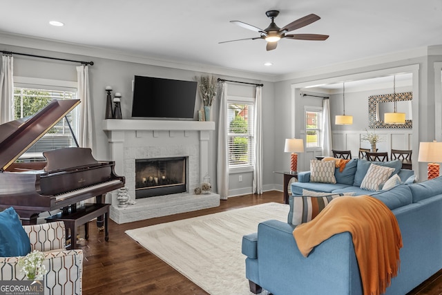 1111 Cobblestone Dr, Bogart, GA 30622 - living area featuring healthy amount of natural light, a ceiling fan, ornamental molding, a fireplace, and dark wood finished floors