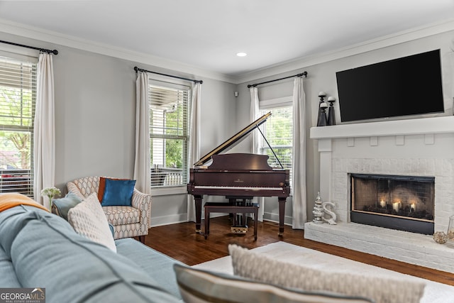 1111 Cobblestone Dr, Bogart, GA 30622 - living room featuring ornamental molding, wood finished floors, a brick fireplace, baseboards, and recessed lighting
