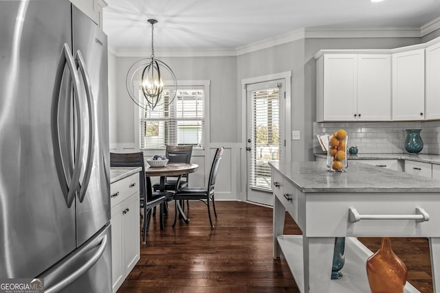 1111 Cobblestone Dr, Bogart, GA 30622 - kitchen with freestanding refrigerator, dark wood finished floors, a chandelier, white cabinets, and pendant lighting