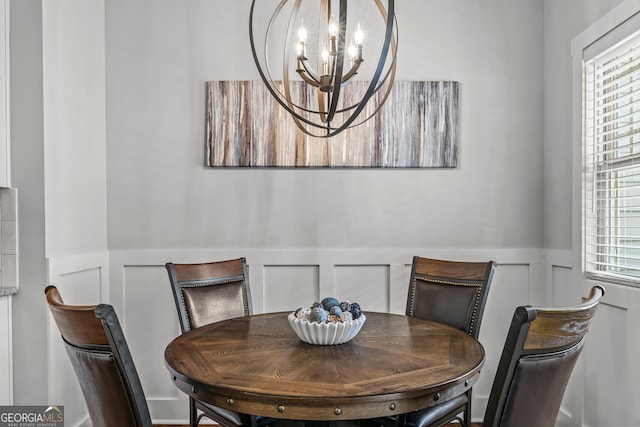 1111 Cobblestone Dr, Bogart, GA 30622 - dining area featuring wainscoting, a chandelier, and a decorative wall