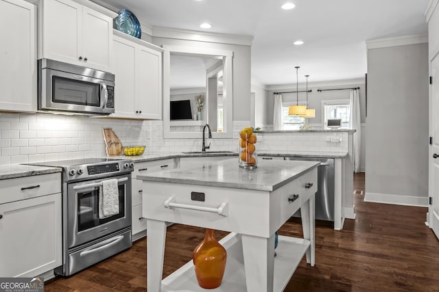 1111 Cobblestone Dr, Bogart, GA 30622 - kitchen with stainless steel appliances, recessed lighting, ornamental molding, white cabinetry, and backsplash