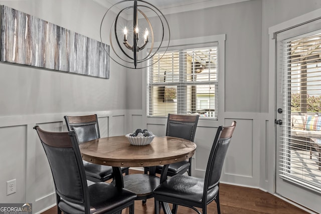 1111 Cobblestone Dr, Bogart, GA 30622 - dining room featuring a decorative wall, a chandelier, wainscoting, and dark wood-style floors