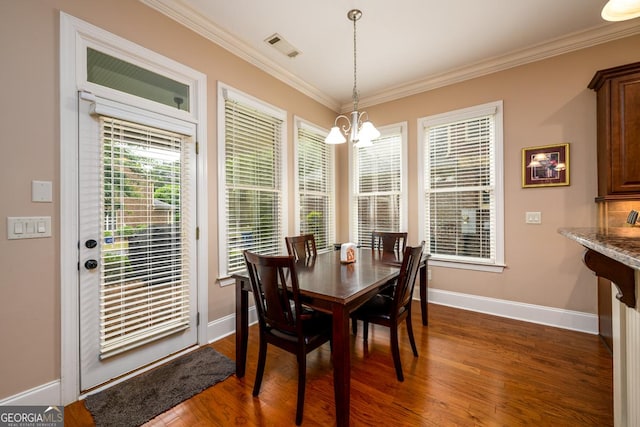 13042 Dartmore Ave, Alpharetta, GA 30005 - dining area featuring a chandelier, dark wood-type flooring, baseboards, and ornamental molding