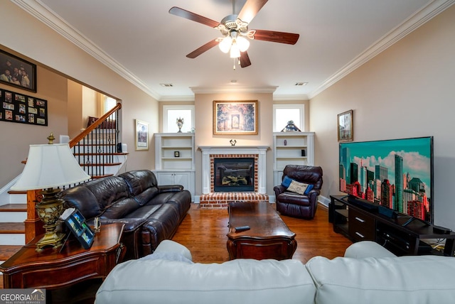 13042 Dartmore Ave, Alpharetta, GA 30005 - living room with ceiling fan, crown molding, wood finished floors, stairs, and a brick fireplace
