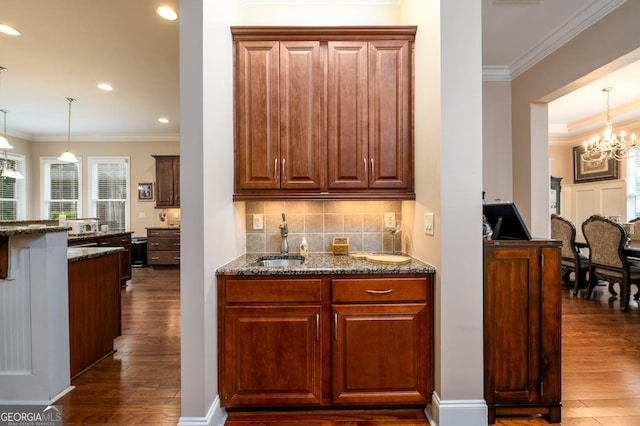 13042 Dartmore Ave, Alpharetta, GA 30005 - kitchen featuring a sink, dark wood-style floors, backsplash, dark stone counters, and crown molding