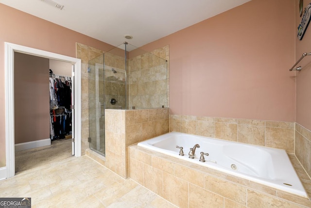 13042 Dartmore Ave, Alpharetta, GA 30005 - bathroom with a garden tub, a stall shower, and a walk in closet