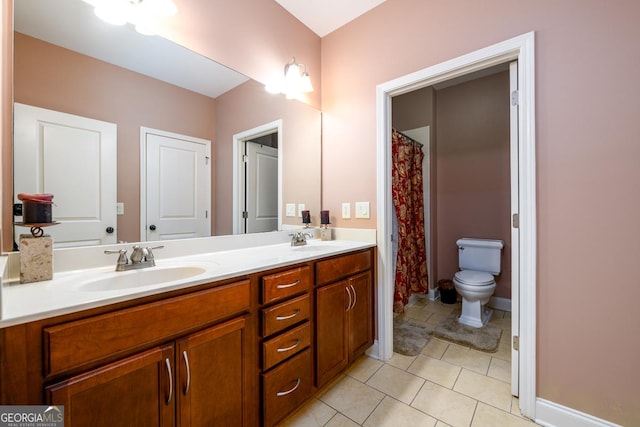 13042 Dartmore Ave, Alpharetta, GA 30005 - full bath with double vanity, toilet, tile patterned floors, and baseboards