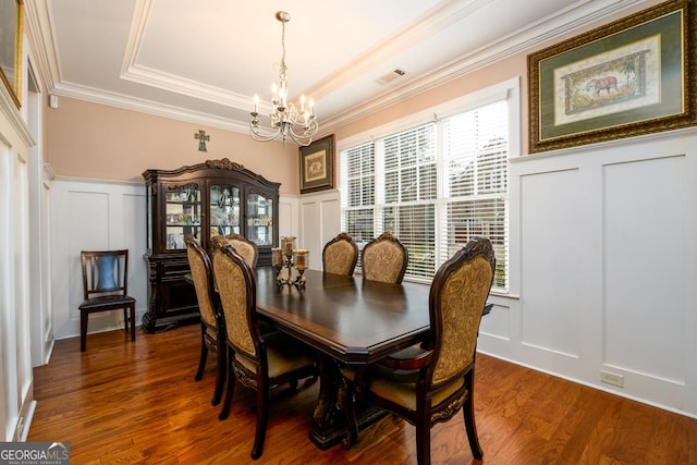 13042 Dartmore Ave, Alpharetta, GA 30005 - dining room featuring a decorative wall, a chandelier, a tray ceiling, crown molding, and wood finished floors