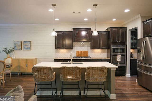 6298 Pierless Ave, Sugar Hill, GA 30518 - kitchen featuring stainless steel appliances, custom range hood, light countertops, tasteful backsplash, and a kitchen breakfast bar