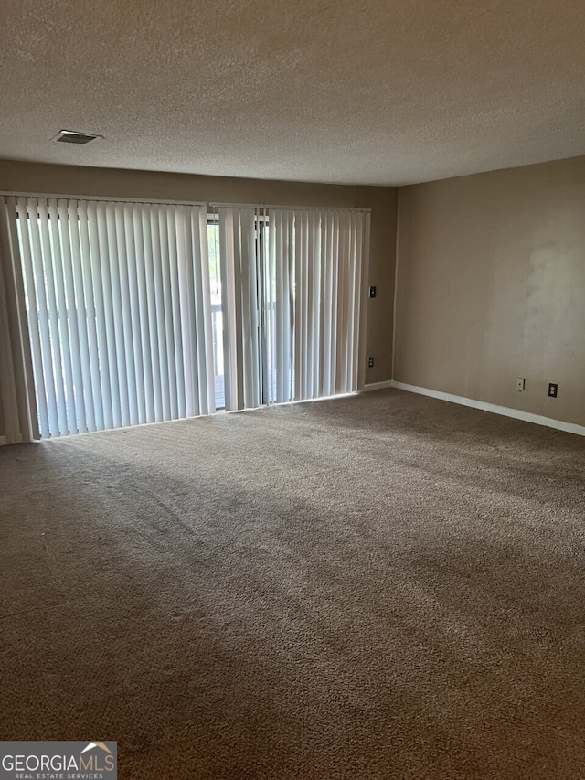 3575 Oakvale Rd Unit 706, Decatur, GA 30034 - carpeted spare room with a textured ceiling and baseboards