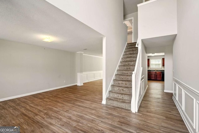 3731 Laramie Rd, Ellenwood, GA 30294 - staircase with wood finished floors and a textured ceiling