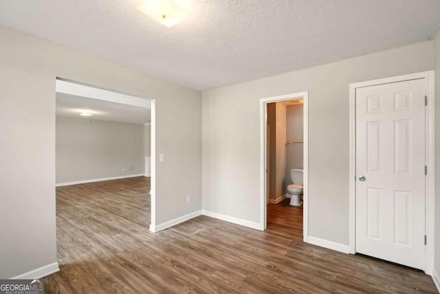 3731 Laramie Rd, Ellenwood, GA 30294 - spare room with wood finished floors, a textured ceiling, and baseboards