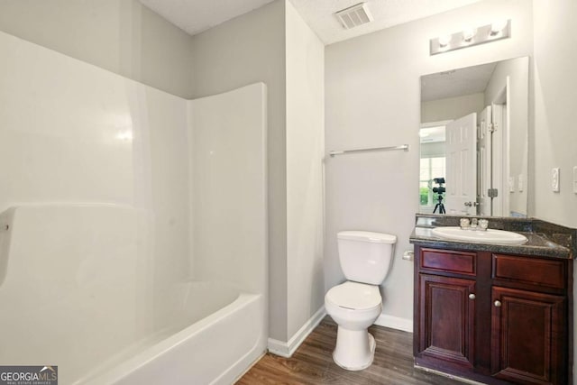 3731 Laramie Rd, Ellenwood, GA 30294 - bathroom with wood finished floors, vanity, toilet, baseboards, and shower / bath combination