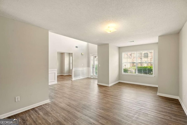 3731 Laramie Rd, Ellenwood, GA 30294 - spare room with a textured ceiling, wood finished floors, and baseboards