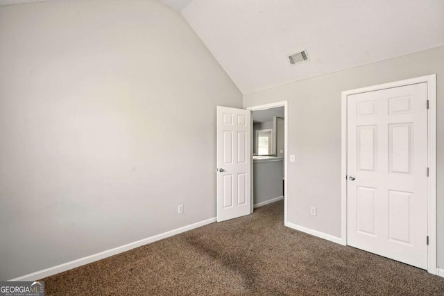 3731 Laramie Rd, Ellenwood, GA 30294 - unfurnished bedroom featuring vaulted ceiling, carpet, and baseboards