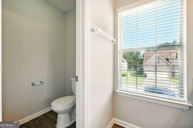3731 Laramie Rd, Ellenwood, GA 30294 - bathroom with baseboards, toilet, wood finished floors, and healthy amount of natural light