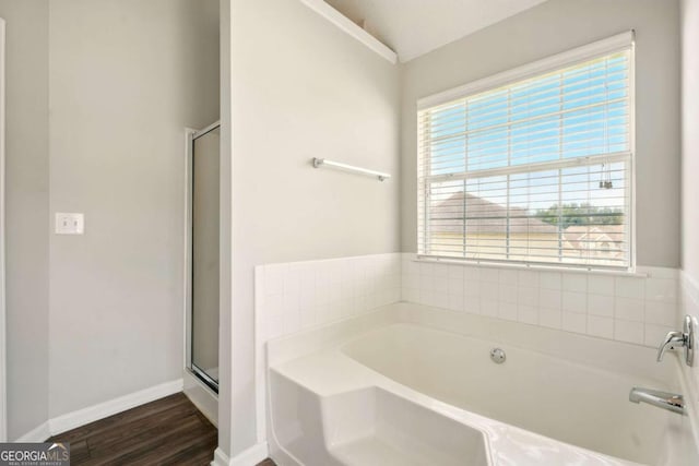 3731 Laramie Rd, Ellenwood, GA 30294 - full bathroom featuring a garden tub, wood finished floors, a stall shower, and baseboards