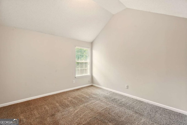 3731 Laramie Rd, Ellenwood, GA 30294 - carpeted empty room featuring vaulted ceiling and baseboards