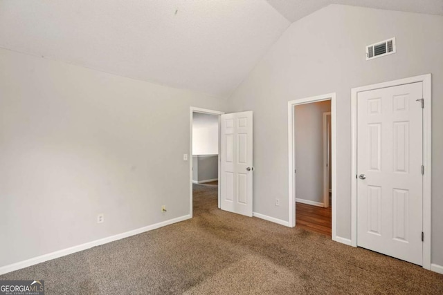 3731 Laramie Rd, Ellenwood, GA 30294 - unfurnished bedroom featuring carpet floors, vaulted ceiling, and baseboards