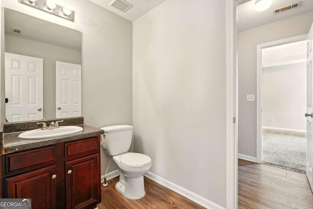 3731 Laramie Rd, Ellenwood, GA 30294 - bathroom featuring wood finished floors, toilet, vanity, and baseboards