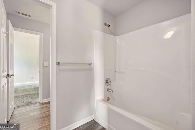 3731 Laramie Rd, Ellenwood, GA 30294 - full bath with tub / shower combination, wood finished floors, and baseboards