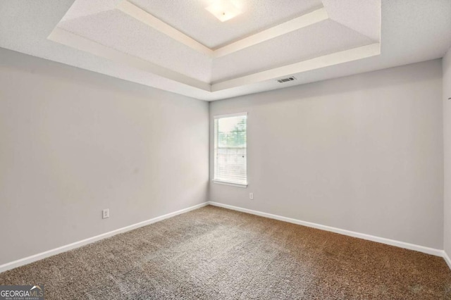 3731 Laramie Rd, Ellenwood, GA 30294 - empty room featuring a tray ceiling, carpet, and baseboards