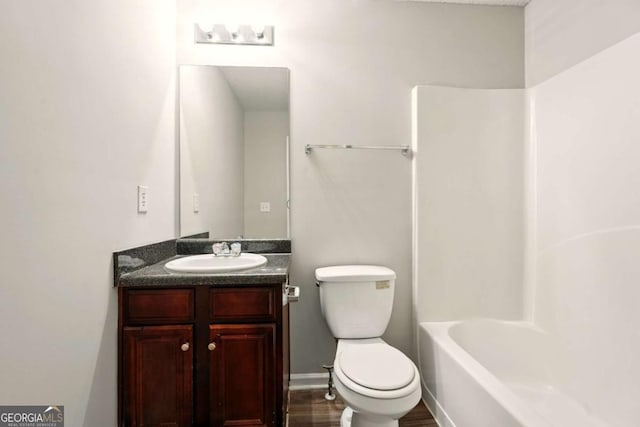 3731 Laramie Rd, Ellenwood, GA 30294 - bathroom with toilet, vanity, tub / shower combination, and wood finished floors