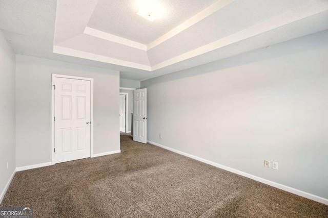 3731 Laramie Rd, Ellenwood, GA 30294 - unfurnished bedroom with a raised ceiling, carpet floors, and baseboards